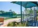 View of tennis courts with shaded seating, showcasing the community's active lifestyle amenities at 2348 Rolling View Dr, Spring Hill, FL 34606