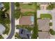 This aerial image shows a home with a screened-in pool, lush landscaping, and a well-maintained yard in a desirable community at 2526 Brinley Dr, Trinity, FL 34655