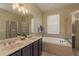 Bright bathroom features a soaking tub, tiled shower, and double sinks with updated fixtures at 2526 Brinley Dr, Trinity, FL 34655