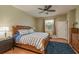 Comfortable bedroom features a ceiling fan, wood floors, and large window allowing natural light at 2526 Brinley Dr, Trinity, FL 34655