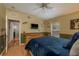 Bedroom with a light wood frame bed, natural light, and a flat screen TV at 2526 Brinley Dr, Trinity, FL 34655