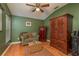 Bonus room with hardwood flooring, comfortable seating, a ceiling fan and a unique wood cabinet at 2526 Brinley Dr, Trinity, FL 34655