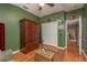 This green bonus room features wood floors, closet space, and a unique wood cabinet at 2526 Brinley Dr, Trinity, FL 34655