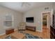 Bonus room with hardwood flooring, TV, closet space, and a decor table at 2526 Brinley Dr, Trinity, FL 34655