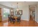 Open-concept dining room with a view of the entry and a light fixture at 2526 Brinley Dr, Trinity, FL 34655