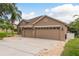 Charming single-story home showcasing a spacious driveway and a two-car garage at 2526 Brinley Dr, Trinity, FL 34655