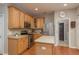 Modern kitchen features stainless steel appliances, wood cabinets, and island with breakfast bar at 2526 Brinley Dr, Trinity, FL 34655