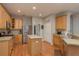 Well-lit kitchen with stainless steel appliances, wood cabinetry, and a convenient island at 2526 Brinley Dr, Trinity, FL 34655