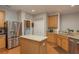 Spacious kitchen with stainless steel refrigerator, island, and ample wood cabinetry at 2526 Brinley Dr, Trinity, FL 34655