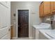 Laundry room features a washer and dryer, cabinet space, and tile floors at 2526 Brinley Dr, Trinity, FL 34655