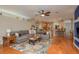 Spacious living room open to kitchen boasts wood floors and a comfortable seating area at 2526 Brinley Dr, Trinity, FL 34655