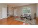 A well-lit living room with a comfortable sofa, hardwood floors, and a view of the front yard at 2526 Brinley Dr, Trinity, FL 34655