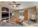 Cozy living room features built-ins, a ceiling fan, and a view of the inviting pool at 2526 Brinley Dr, Trinity, FL 34655