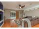 Open living room with wood floors, ceiling fan, and sliding glass doors to the pool at 2526 Brinley Dr, Trinity, FL 34655