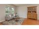 Inviting living room featuring a comfortable sofa, colorful rug, and hardwood floors at 2526 Brinley Dr, Trinity, FL 34655
