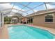 Relaxing screened-in pool with outdoor dining area, ideal for entertaining and enjoying the weather at 2526 Brinley Dr, Trinity, FL 34655