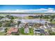 Aerial view showcases the property, nearby homes, and a stunning lake view at 277 Hampshire Ave, Spring Hill, FL 34606