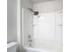 Bathroom featuring a white shower-tub combo with black fixtures and a toilet in the corner at 277 Hampshire Ave, Spring Hill, FL 34606