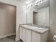 Bathroom with granite countertops, a double sink, and a large mirror with lighting at 277 Hampshire Ave, Spring Hill, FL 34606