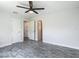 Spacious bedroom featuring plank flooring, a ceiling fan and two closet doors with multiple interior doors at 277 Hampshire Ave, Spring Hill, FL 34606