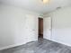 Bright bedroom featuring a neutral color palette and wood-look gray flooring at 277 Hampshire Ave, Spring Hill, FL 34606