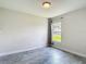 Bright bedroom featuring a neutral color palette, a window and wood-look gray flooring at 277 Hampshire Ave, Spring Hill, FL 34606