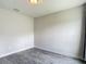 Bright bedroom featuring a neutral color palette and wood-look gray flooring at 277 Hampshire Ave, Spring Hill, FL 34606