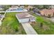 An aerial view shows the home has a well-maintained lawn and driveway, plus an attached two-car garage at 277 Hampshire Ave, Spring Hill, FL 34606