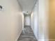 Inviting hallway featuring wood-look tile flooring and neutral paint at 277 Hampshire Ave, Spring Hill, FL 34606