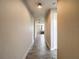Neutral hallway boasts wood-look tile floors and leads to the bedroom at 277 Hampshire Ave, Spring Hill, FL 34606