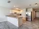 Bright kitchen with white cabinets, granite countertops, and wood-look tile floors at 277 Hampshire Ave, Spring Hill, FL 34606