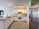 Bright kitchen with white cabinets, granite countertops, and stainless steel appliances at 277 Hampshire Ave, Spring Hill, FL 34606