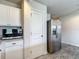 Kitchen area showcasing stainless steel fridge and modern microwave at 277 Hampshire Ave, Spring Hill, FL 34606