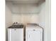 Laundry room featuring white washer and dryer and shelf at 277 Hampshire Ave, Spring Hill, FL 34606