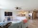 Open-concept living room featuring a ceiling fan, open kitchen, and an entertainment center with an electric fireplace at 277 Hampshire Ave, Spring Hill, FL 34606