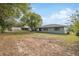 Large backyard with mature trees, a shed, and plenty of room to relax at 3427 Charmwood Ave, Spring Hill, FL 34609