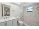 Updated bathroom featuring a tiled shower with a window, a modern vanity, and neutral walls at 3427 Charmwood Ave, Spring Hill, FL 34609