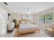 Light-filled bedroom with a comfortable bed, stylish decor, and a view to an adjacent bathroom at 3427 Charmwood Ave, Spring Hill, FL 34609