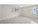 Bright, spacious bedroom with tiled floors, and two windows providing great natural light at 3427 Charmwood Ave, Spring Hill, FL 34609