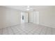 An open bedroom with tiled flooring and neutral walls leads to other rooms in the house at 3427 Charmwood Ave, Spring Hill, FL 34609