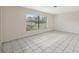 Bright, empty room with large window and tile flooring, ready for personalization at 3427 Charmwood Ave, Spring Hill, FL 34609