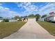 A well-maintained house with a long driveway and a beautiful yard at 3427 Charmwood Ave, Spring Hill, FL 34609