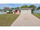 Inviting single-story home with a well-manicured lawn and a long, paved driveway at 3427 Charmwood Ave, Spring Hill, FL 34609