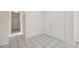 Hallway featuring tiled flooring and white walls that leads to other rooms in the house at 3427 Charmwood Ave, Spring Hill, FL 34609