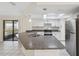 Modern kitchen with granite countertops, stainless steel appliances, and lots of natural light through sliding door at 3427 Charmwood Ave, Spring Hill, FL 34609