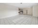 Expansive empty living room with tile flooring, recessed lighting, and open access to kitchen at 3427 Charmwood Ave, Spring Hill, FL 34609
