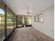 Enclosed patio with brick flooring, ceiling fan, and views of the yard at 3427 Charmwood Ave, Spring Hill, FL 34609