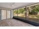 Screened in patio with brick floors leading to an expansive backyard at 3427 Charmwood Ave, Spring Hill, FL 34609