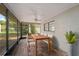 Screened patio with a ceiling fan and backyard view, ideal for outdoor dining at 3427 Charmwood Ave, Spring Hill, FL 34609