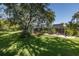 Aerial view showcasing the expansive backyard, screened pool, deck, and lush landscaping surrounding the home at 3609 Montclair Dr, New Port Richey, FL 34655